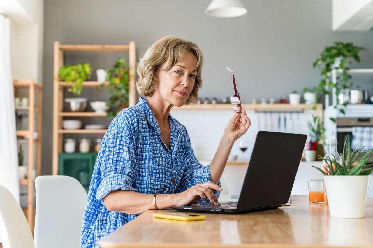 Woman working on a laptop at home office, earning money online